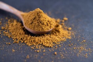 Spices are placed in a spoon and placed on the cement ground